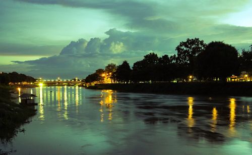 Scenic view of lake against sky at night