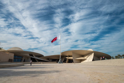 Flag in city against sky