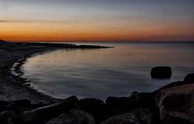 Scenic view of calm sea at sunset