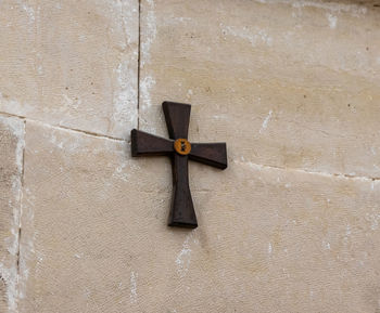 Close-up of cross against wall