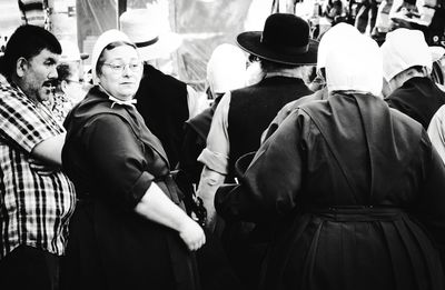 Rear view of people standing on street