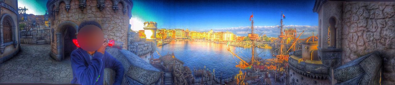 built structure, architecture, building exterior, city, water, tree trunk, river, bridge, blue, outdoors, sky, riverbank, canal, promenade, no people