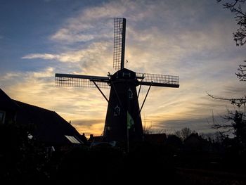 Low angle view of traditional windmill against sky