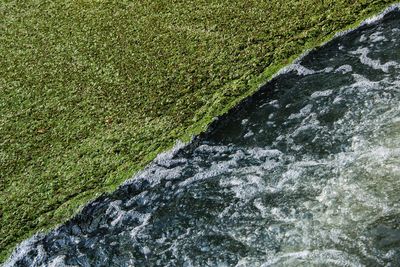 High angle view of water flowing through rocks