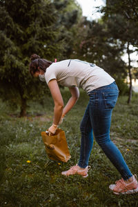 Side view of woman with umbrella on field