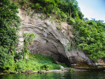 Scenic view of waterfall against sky