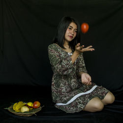 Young woman sitting on table