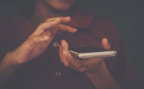 Midsection of man using mobile phone