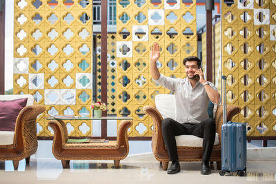 Full length of man sitting on chair