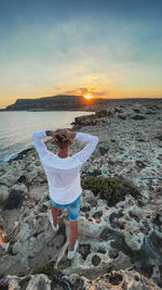 Man on beach during sunset