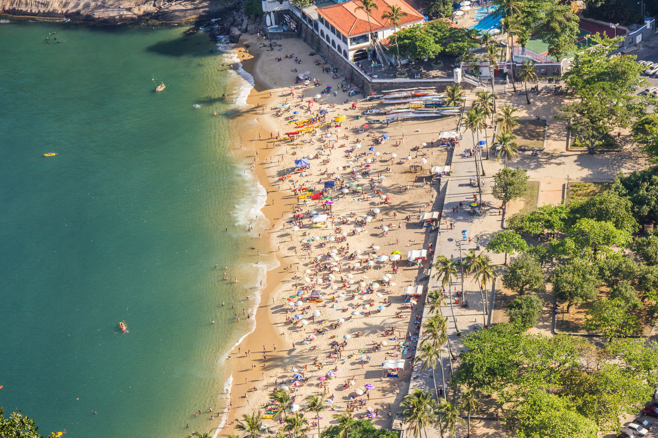 HIGH ANGLE VIEW OF BEACH BY CITY IN SEA