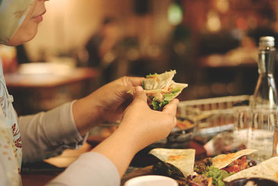 A woman is eating in a restaurant