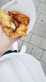 Low section of woman holding food