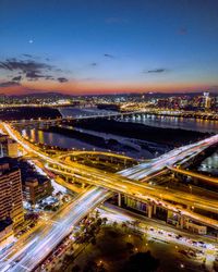 High angle view of elevated road and cityscape at night