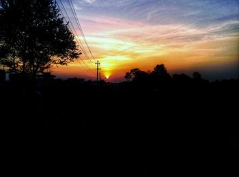 Silhouette trees against sky during sunset