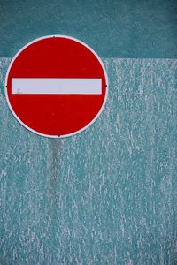 Close-up of road sign on wall