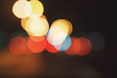 Defocused image of lights against sky at night