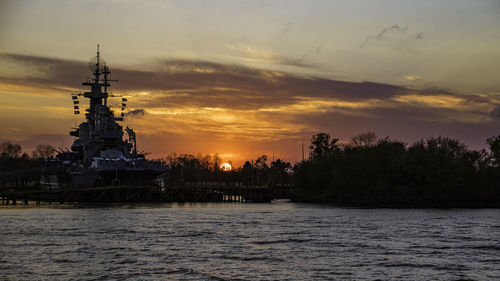 Scenic view of river against sky during sunset