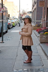 Full length of woman standing on road