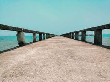 Bridge over sea against clear sky