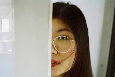 Close-up portrait of young woman at home