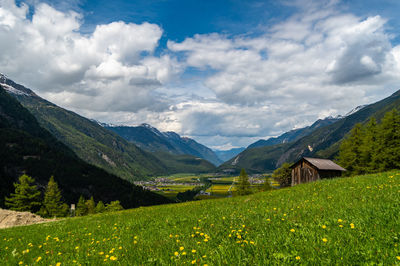 Scenic view of field and mountains against sky