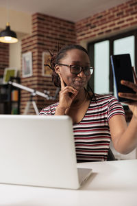 Young woman using laptop at home