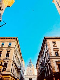 Low angle view of buildings against blue sky