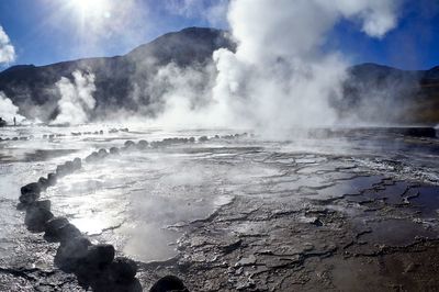 Smoke emitting from volcanic mountain against sky