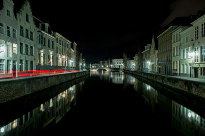 Canal in city at night