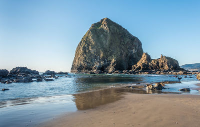 A view of the haystack rock monolith at cannon beach, oregon.