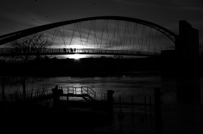 Bridge over river at sunset