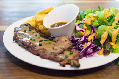 Meat and curry with salad on plate