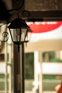 Close-up of illuminated lamp hanging on ceiling