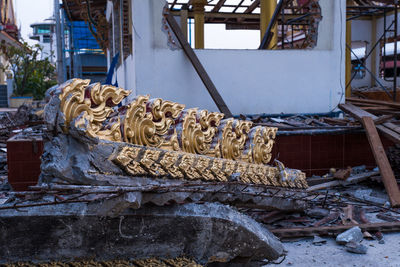 Statue of angel by metal structure