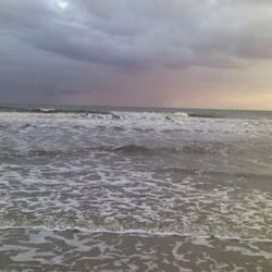 Scenic view of sea against cloudy sky