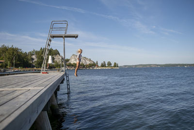 Girl jumping from diving tower