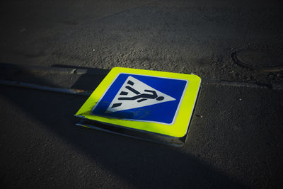 High angle view of road sign on street