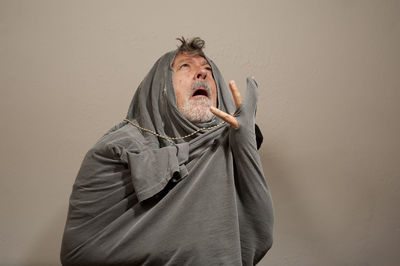 Midsection of man standing against wall