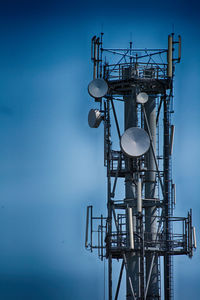 Low angle view of communications tower against sky