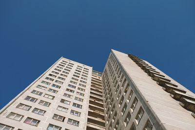 Low angle view of modern building against blue sky