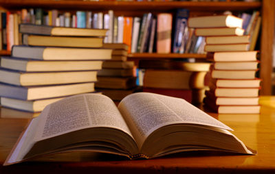 Open book on table in library