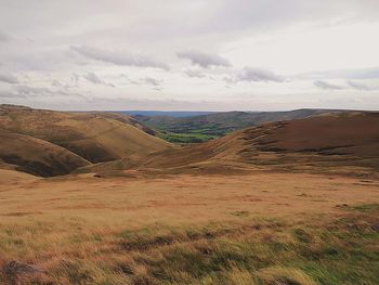 Scenic view of landscape against cloudy sky