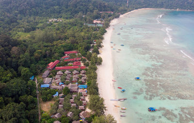 High angle view of houses at beach against trees