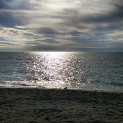 Scenic view of sea against cloudy sky