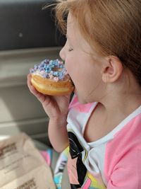 Close-up of girl eating donut