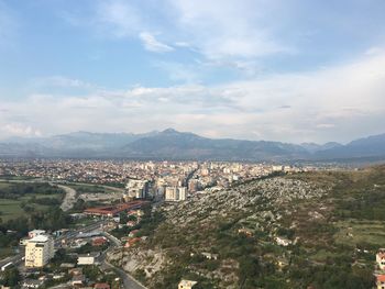 High angle view of cityscape against cloudy sky