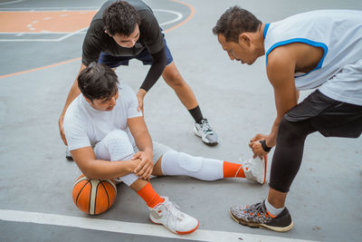 High angle view of basketball player sitting at court