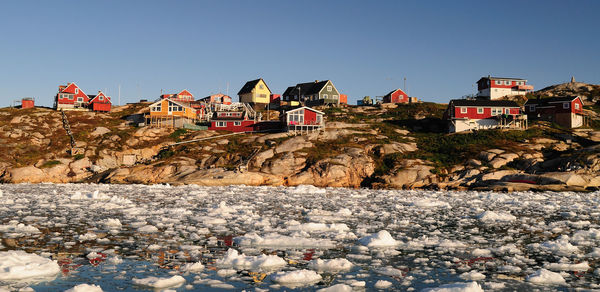 View of buildings against clear blue sky