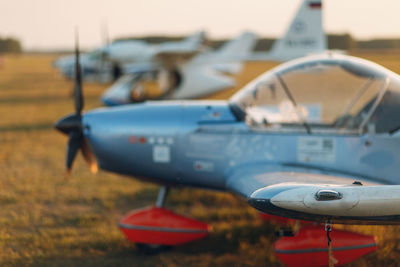 Close-up of airplane on runway against sky